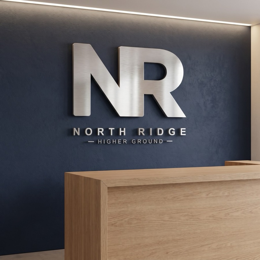Brushed metal logo on a reception wall